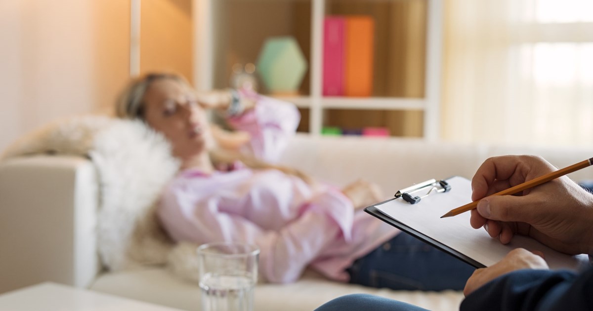 Woman lying in couch during hypnotherapy